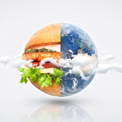 The earth half as a hamburger and half as seen from space with clouds. Photo collage